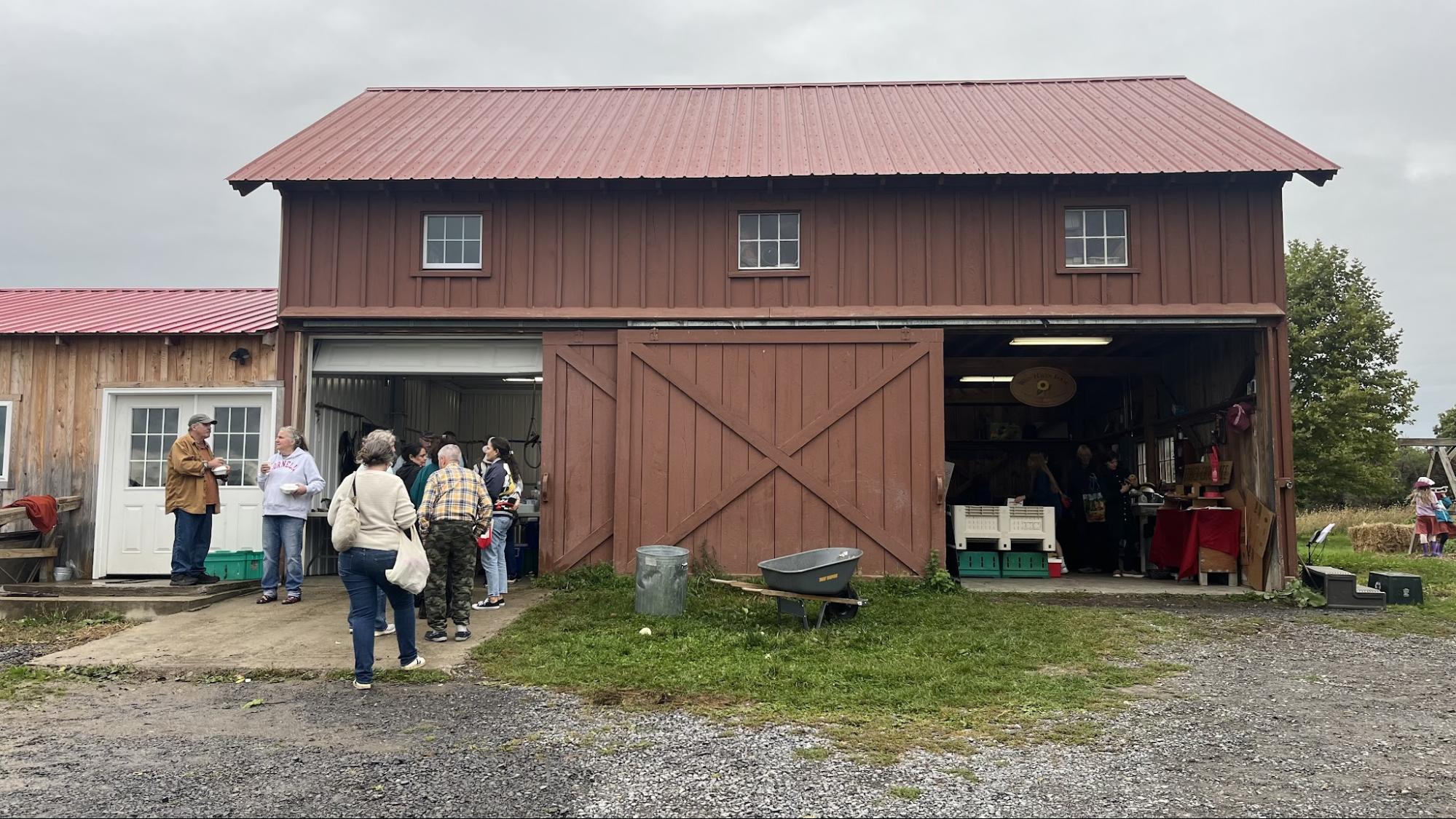 People line up for tamales at a barn in Ithaca NY